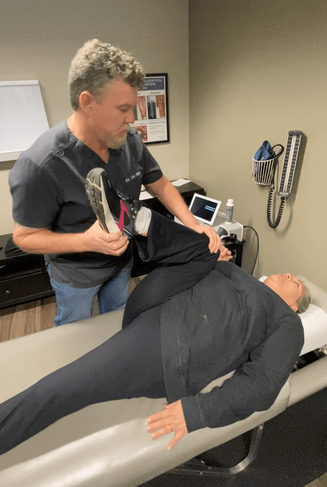 Dr. Miller performing a knee mobilization technique at Chiro-Med in Orland Park, IL