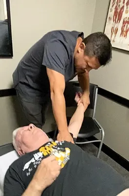 Dr. Eric Miller performing an arm adjustment