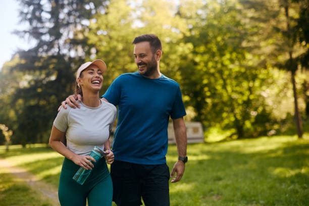 Active couple walking together outdoors on a sunny day
